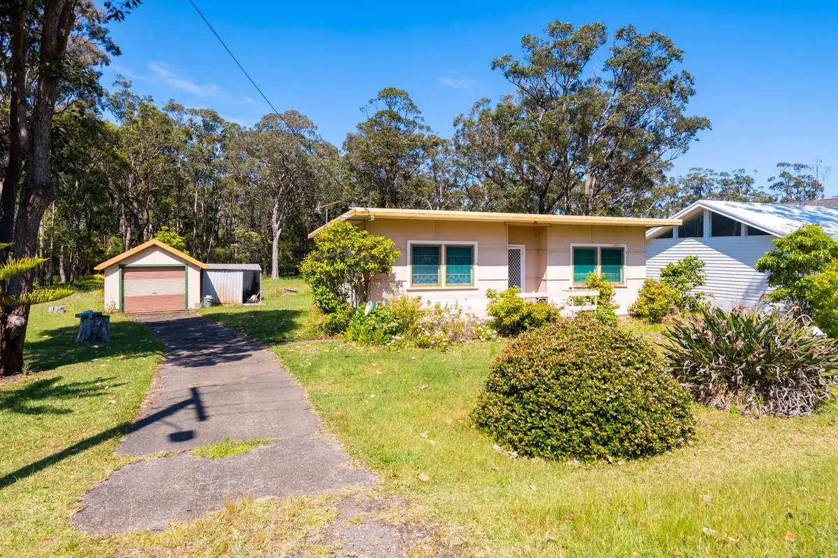 Before: a single-storey cottage with a detached garage on the bushland block in Huskisson, NSW